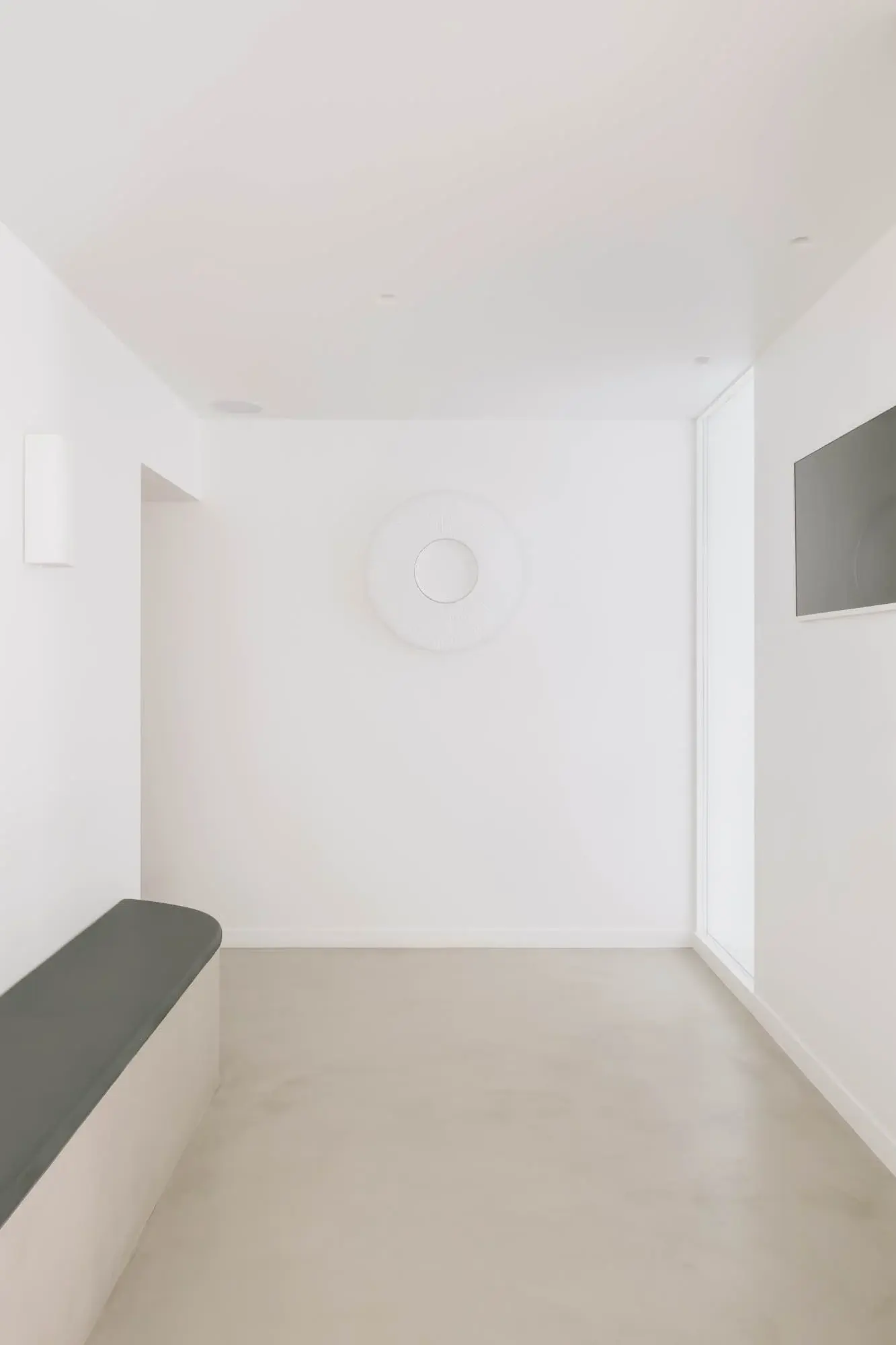 La circulation intérieure du cabinet, avec une banquette et des portes de consultation.